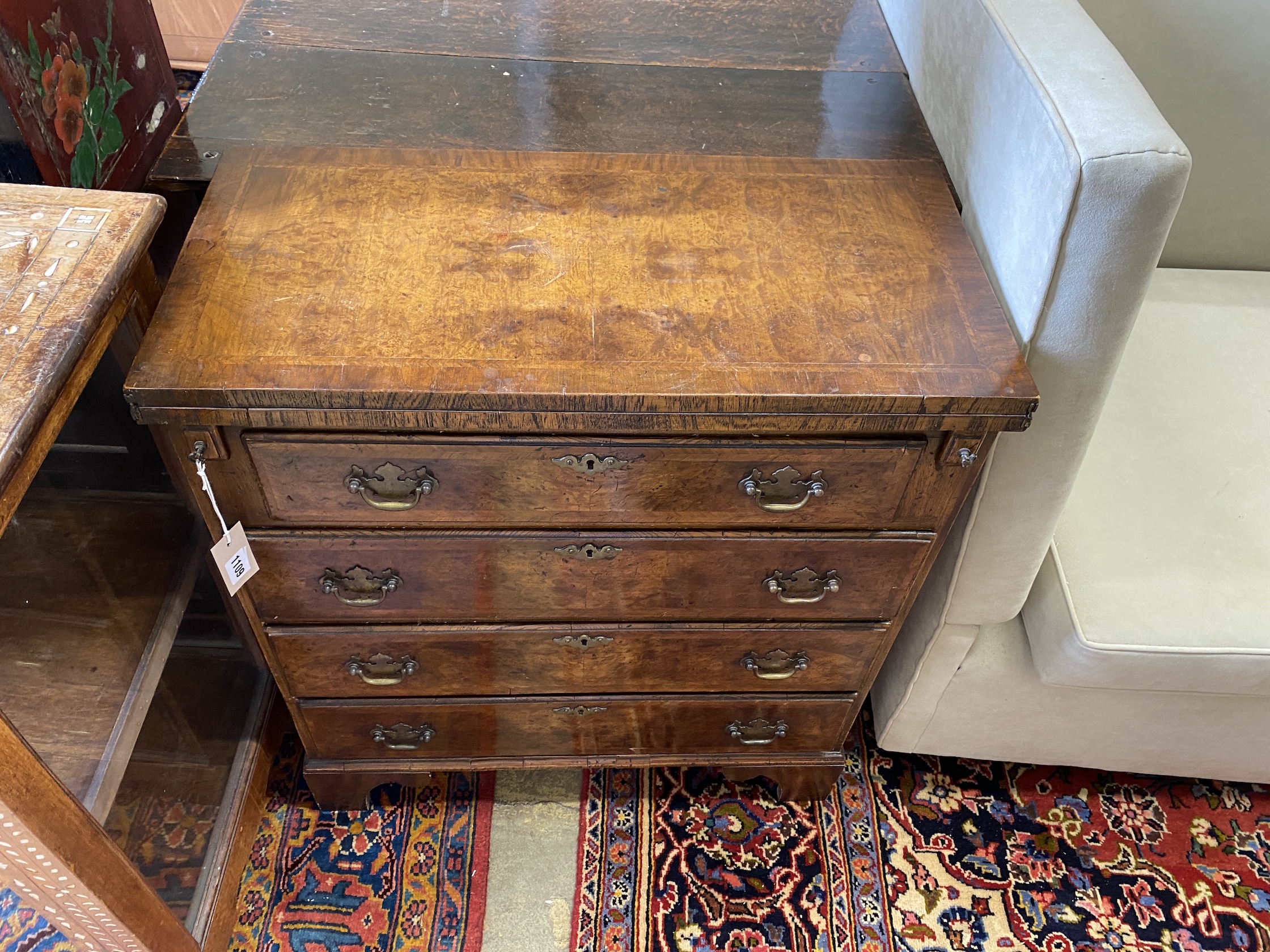 A Queen Anne revival feather banded walnut bachelor's chest, width 69cm, depth 33cm, height 78cm